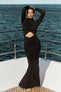 Image of woman in black maxi dress.